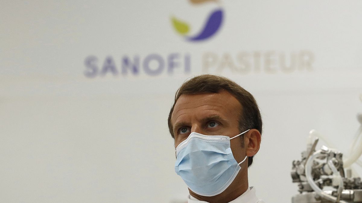 French President Emmanuel Macron visits an industrial development laboratory at the French drugmaker's vaccine unit Sanofi Pasteur plant in Marcy-l'Etoile, near Lyon.