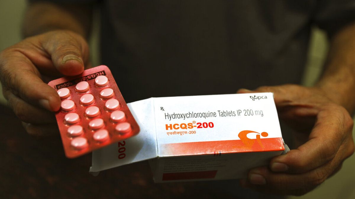A chemist displays hydroxychloroquine tablets