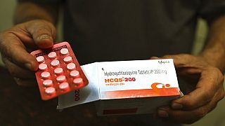 A chemist displays hydroxychloroquine tablets