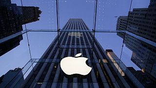 Apple logo hangs in the glass box entrance to the company's Fifth Avenue store in New York