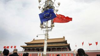 Visitors walk under flags of European Union and China in front of The Tiananmen Gate in Beijing Friday, April 25, 2008