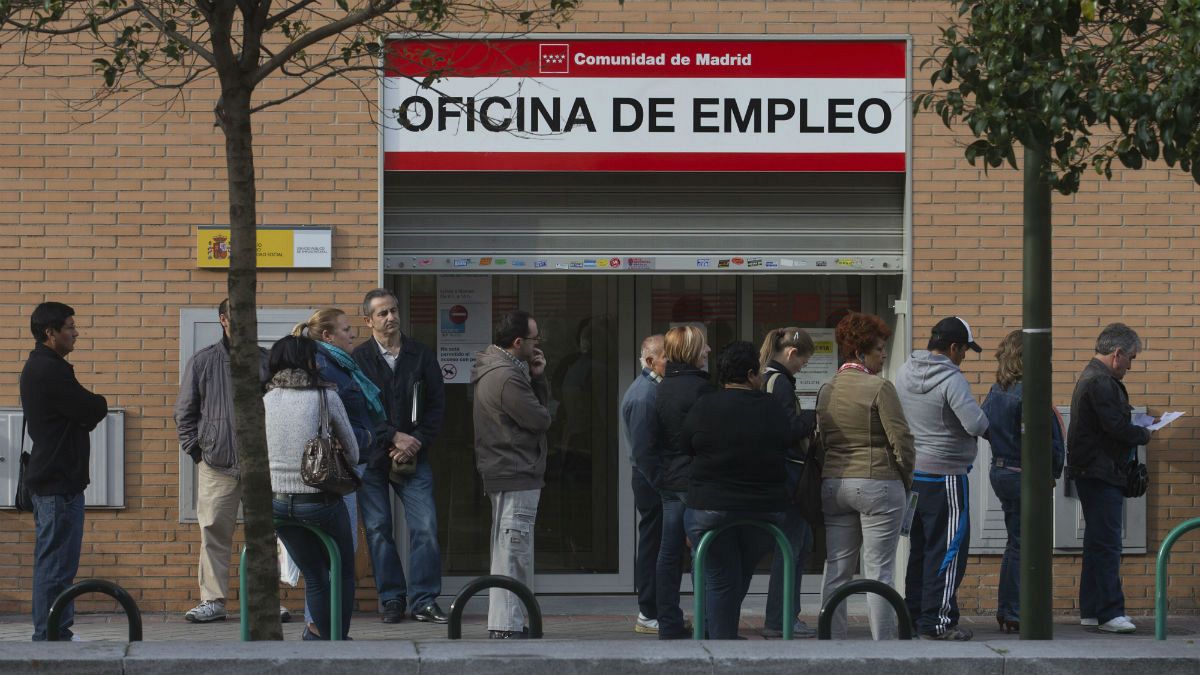People queue outside an unemployment registry office in Madrid, Spain