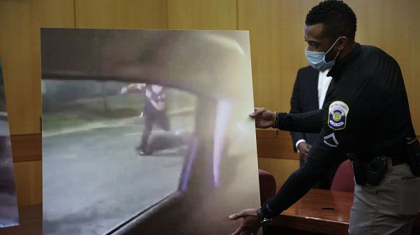 An officer holds up a display during a Fulton County District Attorney Paul L. Howard Jr. speaks at a news conference An officer holds up a display during a Fulton County District Attorney Paul L. Howard Jr. speaks at a news conference