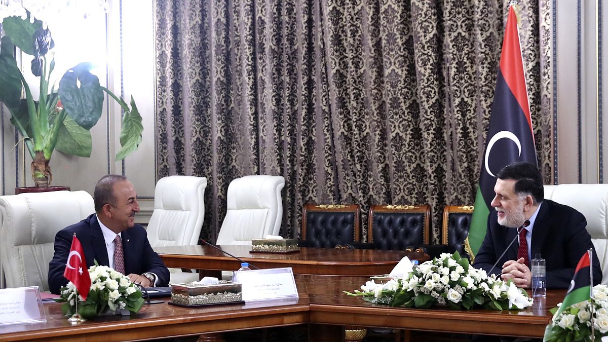 Turkey's Foreign Minister Mevlut Cavusoglu, right, and Fayez Sarraj