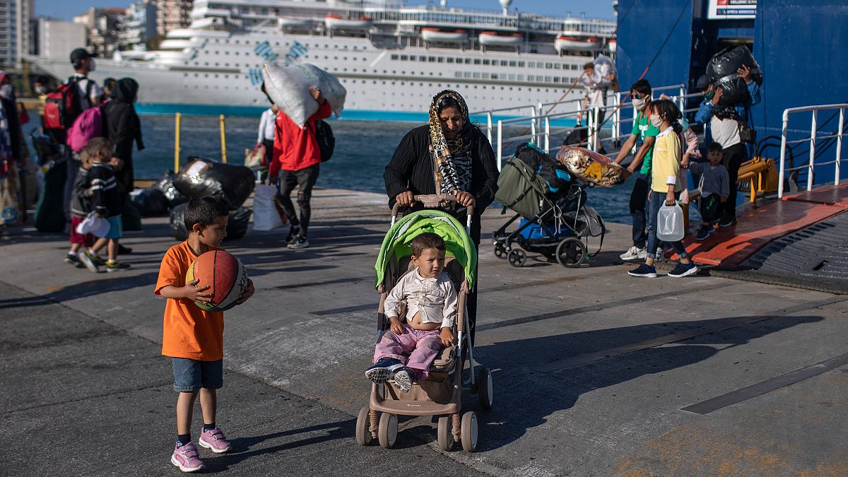 Refugees and migrants wearing masks arrive at the port of Piraeus, near Athens. 11 June 2020.