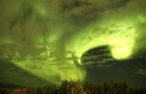 Wide shot thern lights shine through moving clouds