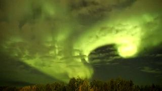 Wide shot thern lights shine through moving clouds