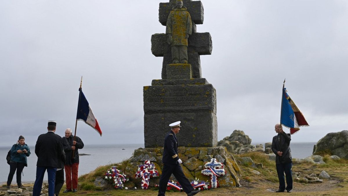 People take part in a ceremony to commemorate General de Gaulle's "Appeal of June 18th" during World War II, in the island of Ile-de-Sein, on June 18, 2020.