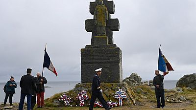 People take part in a ceremony to commemorate General de Gaulle's "Appeal of June 18th" during World War II, in the island of Ile-de-Sein, on June 18, 2020.