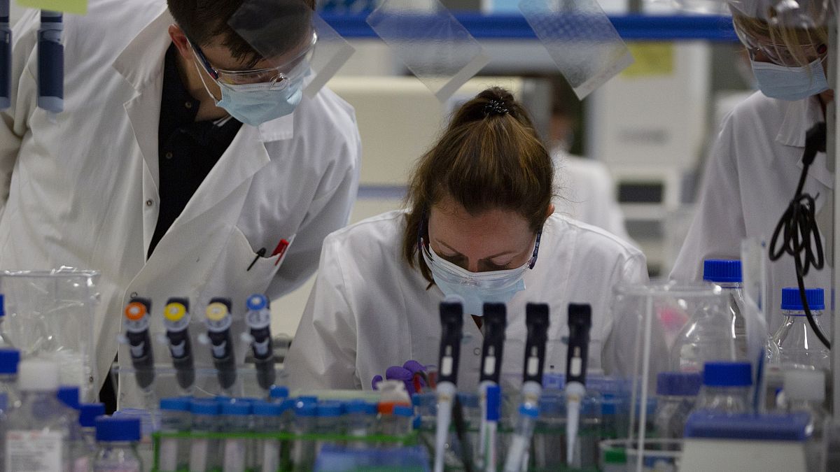 FILE: Lab technicians speak with each other during research on coronavirus, at Johnson & Johnson subsidiary Janssen Pharmaceutical in Beerse, Belgium, June 17, 2020 