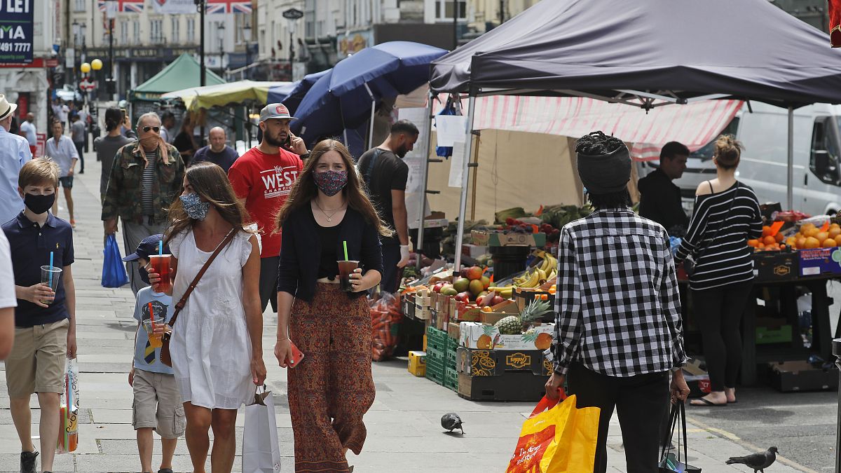 Customers walk along Portobello Road Market in London, Wednesday, May 27, 2020.