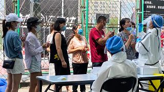 Residents line up to get tested at a coronavirus testing center set up outside a sports facility in Beijing. 16 June 2020