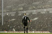 Tottenham Hotspur's goalkeeper Paul Robinson stands alone in the pouring rain during a Premier League match against Liverpool in 2006.