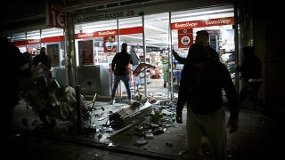 Goods lie on the floor after people broke into a shop on Marienstrasse in Stuttgart, Germany, Sunday, June 21, 2020.