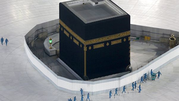 workers disinfect the ground around the Kaaba workers disinfect the ground around the Kaaba