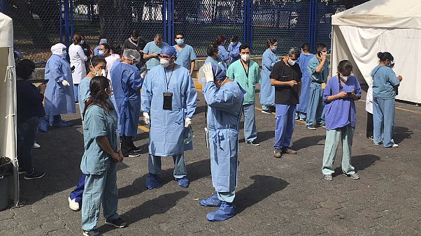 Juarez public hospital health workers wait on a street after a 7.5 earthquake sent them out from their work areas, in Mexico City, Tuesday, June 23, 2020. Juarez public hospital health workers wait on a street after a 7.5 earthquake sent them out from their work areas, in Mexico City, Tuesday, June 23, 2020.