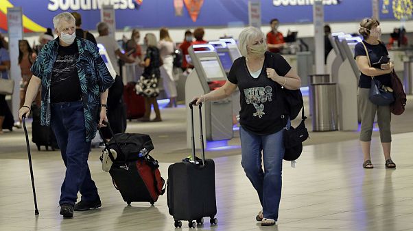 Tampa, FLORIDA, UNITED STATES,Passengers wearing personal protective face masks walk past the Southwest Airlines ticket counter Tampa, FLORIDA, UNITED STATES,Passengers wearing personal protective face masks walk past the Southwest Airlines ticket counter