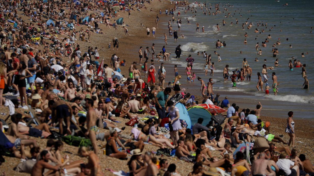 On Britain's hottest day of the year so far with temperatures reaching 32.6 degrees at Heathrow, people relax on Brighton Beach in Brighton, England, Wednesday