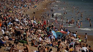 On Britain's hottest day of the year so far with temperatures reaching 32.6 degrees at Heathrow, people relax on Brighton Beach in Brighton, England, Wednesday