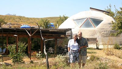 Laura Davies and Dave Buchanan standing outside their eco home. Laura Davies and Dave Buchanan standing outside their eco home.