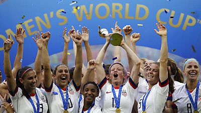 United States' Megan Rapinoe lifts up a trophy after winning the Women's World Cup final soccer match between US and The Netherlands at the Stade de Lyon, France