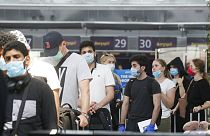 Passengers wearing face masks to protect against coronavirus pass check-in procedure at Boryspil International Airport outside Ukraine's capital Kyiv