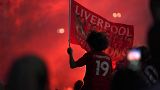 Liverpool supporters celebrates outside Anfield Stadium in Liverpool, England, Thursday, June 25, 2020