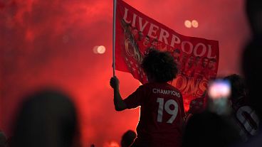 Liverpool supporters celebrates outside Anfield Stadium in Liverpool, England, Thursday, June 25, 2020