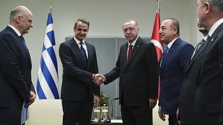 Turkey's President Recep Tayyip Erdogan, centre right, shakes hands with Greece's Prime Minister Kyriakos Mitsotakis,
