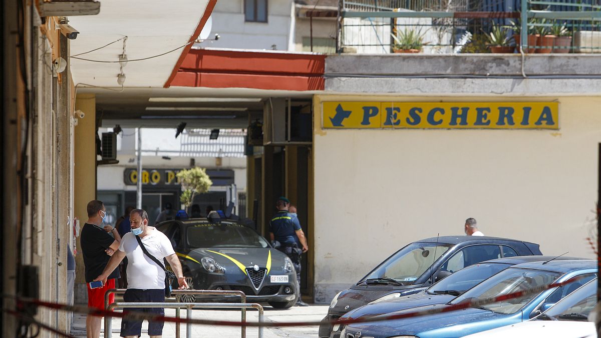Police officers patrol an apartment complex area, Mondragone, Campania, Friday, June 26, 2020.