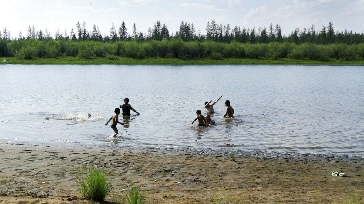 children play in the Krugloe lake outside Verkhoyansk, the Sakha Republic, about 4660 kilometers (2900 miles) northeast of Moscow, Russia.