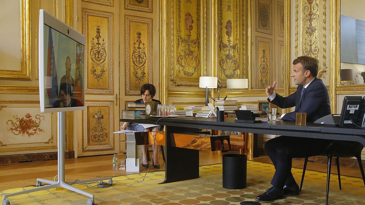 French President Emmanuel Macron talks to Russian President Vladimir Putin during a video conference Friday, June 26, 2020