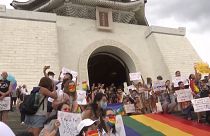 LGBT pride supporters taking group photos on top of the CKS Memorial Hall's stairs