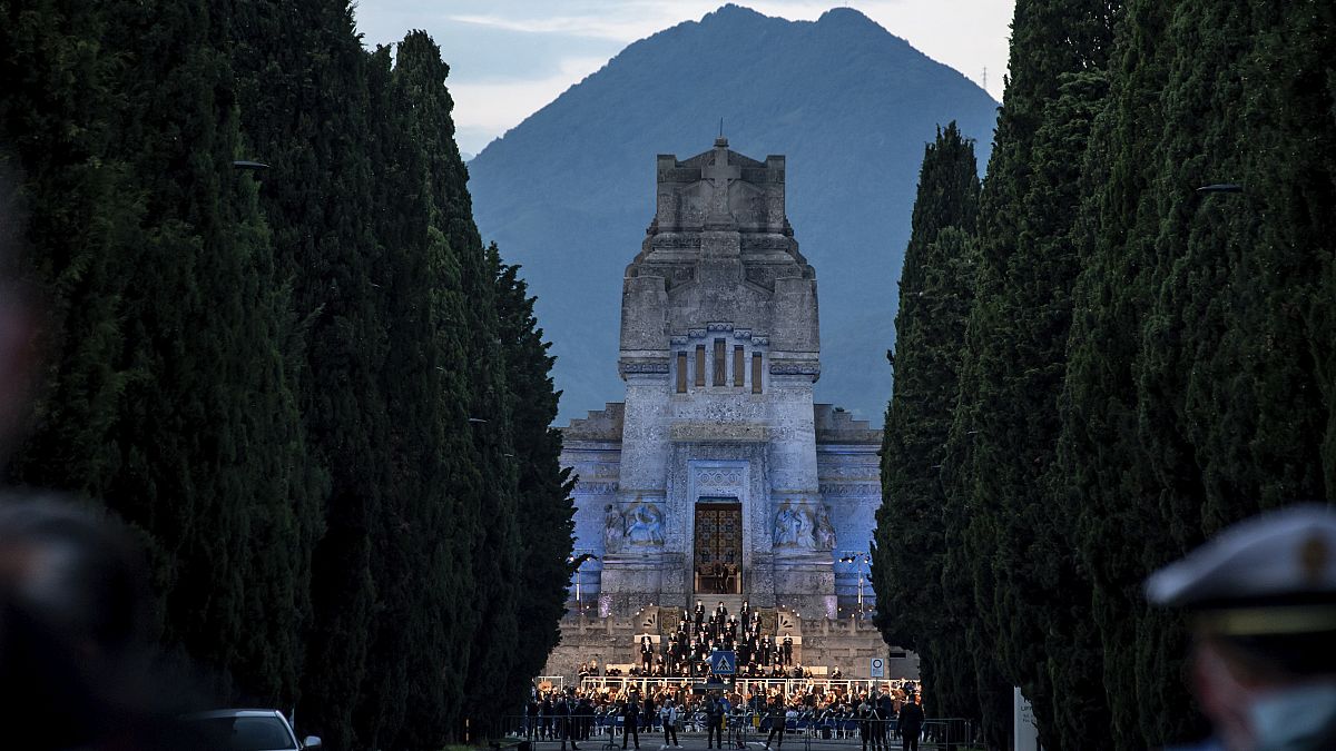 Musicians perform in front of the Bergamo cemetery, Italy, Sunday, June 28, 2020. 