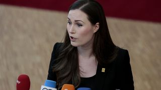 Finnish Prime Minister Sanna Marin speaks with the media as she arrives for an EU summit in Brussels in February.