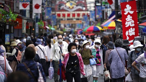 A street is crowded by shoppers in Tokyo A street is crowded by shoppers in Tokyo