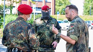Soldiers of the German forces stay in front of the district hall, headquarters of the task force coordinating coronavirus test stations, in Warendorf, Germany, June 24, 2020.