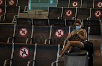 A passenger sits at Barcelona airport in Barcelona, Spain