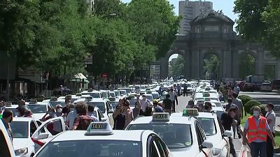 Taxis parked along main avenue near Puerta de Alcala monument