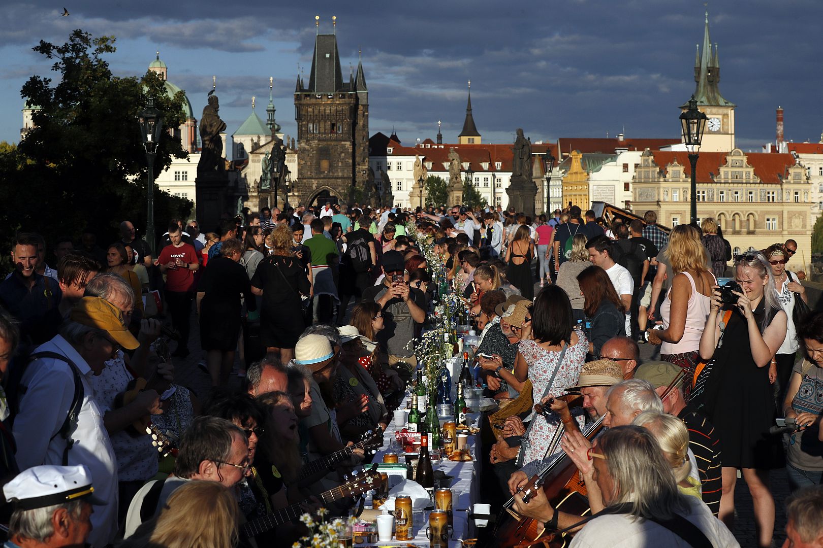 Residents sit to dine on a 500 metre long table set on the medieval Charles Bridge, after restrictions were eased following the coronavirus pandemic in Prague, Czech Republic