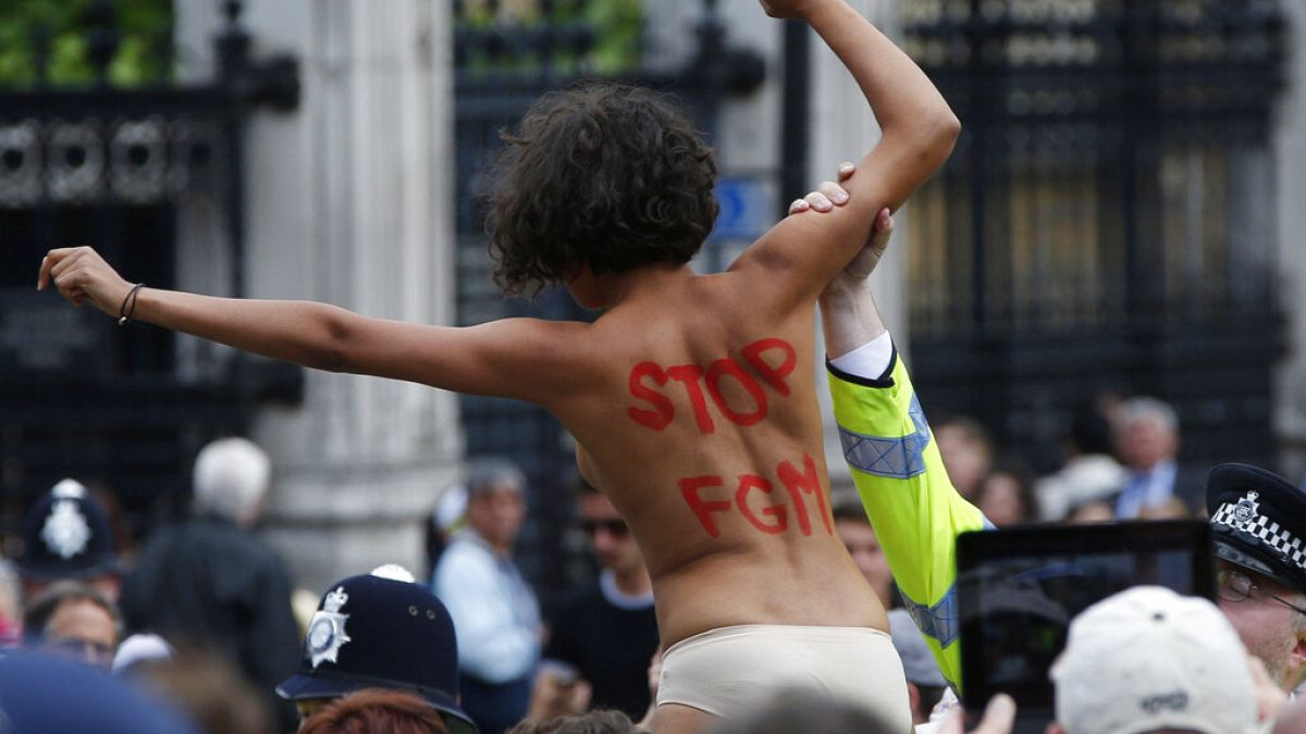 A FEMEN activist shouts slogans against female genital mutilation (FGM) during a protest opposite the Houses of Parliament in London.