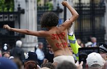 A FEMEN activist shouts slogans against female genital mutilation (FGM) during a protest opposite the Houses of Parliament in London.