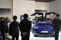 People view the new Tesla Model X during the Brussels Auto Show at the Expo in Brussels, Thursday, Jan. 9, 2020.
