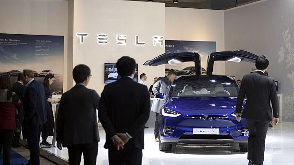 People view the new Tesla Model X during the Brussels Auto Show at the Expo in Brussels, Thursday, Jan. 9, 2020. People view the new Tesla Model X during the Brussels Auto Show at the Expo in Brussels, Thursday, Jan. 9, 2020.