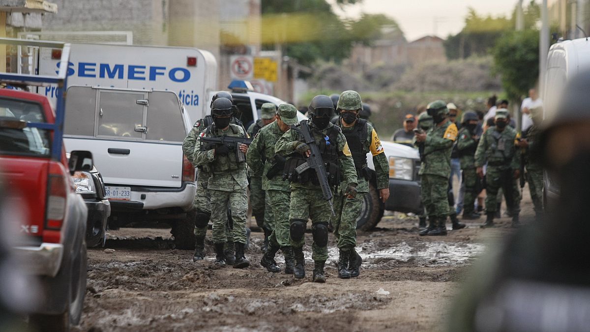 Members of the national guard walk near an unregistered drug rehabilitation center in Irapuato, Mexico, Wednesday, July 1, 2020.