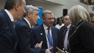 Yakiv Smolii, governor of Ukraine's central bank (C), greets attendees during the IMF/World Bank spring meeting in Washington, DC on April 21, 2018.