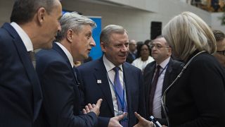 Yakiv Smolii, governor of Ukraine's central bank (C), greets attendees during the IMF/World Bank spring meeting in Washington, DC on April 21, 2018. 