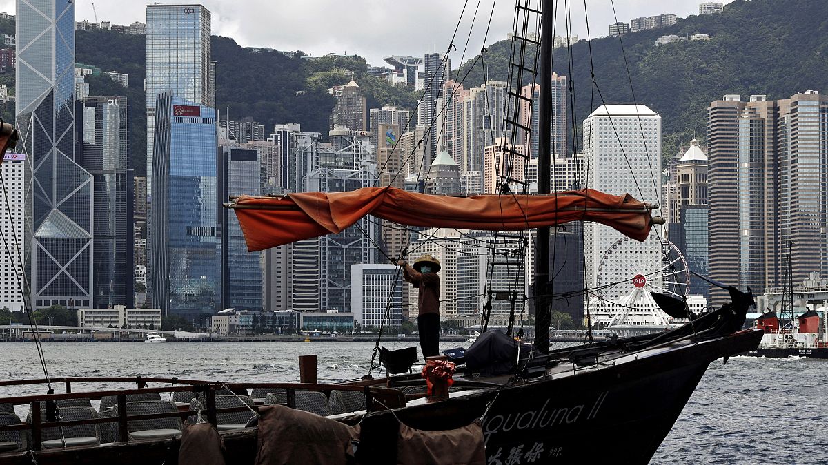 A sailor wearing a face mask to prevent the spread of the new coronavirus, works on a Chinese junk at the Victoria Harbour of Hong Kong, June 27, 2020. 