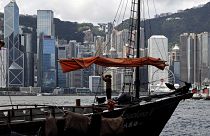 A sailor wearing a face mask to prevent the spread of the new coronavirus, works on a Chinese junk at the Victoria Harbour of Hong Kong, June 27, 2020.