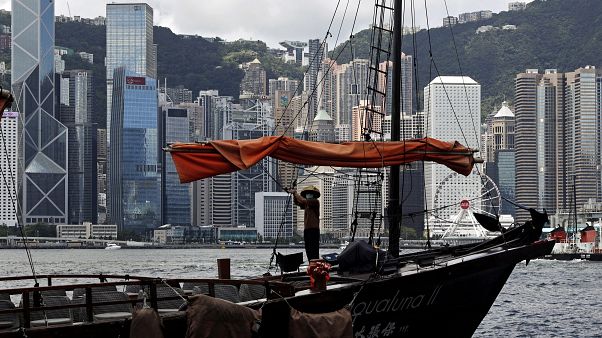 A sailor wearing a face mask to prevent the spread of the new coronavirus, works on a Chinese junk at the Victoria Harbour of Hong Kong, June 27, 2020. A sailor wearing a face mask to prevent the spread of the new coronavirus, works on a Chinese junk at the Victoria Harbour of Hong Kong, June 27, 2020.